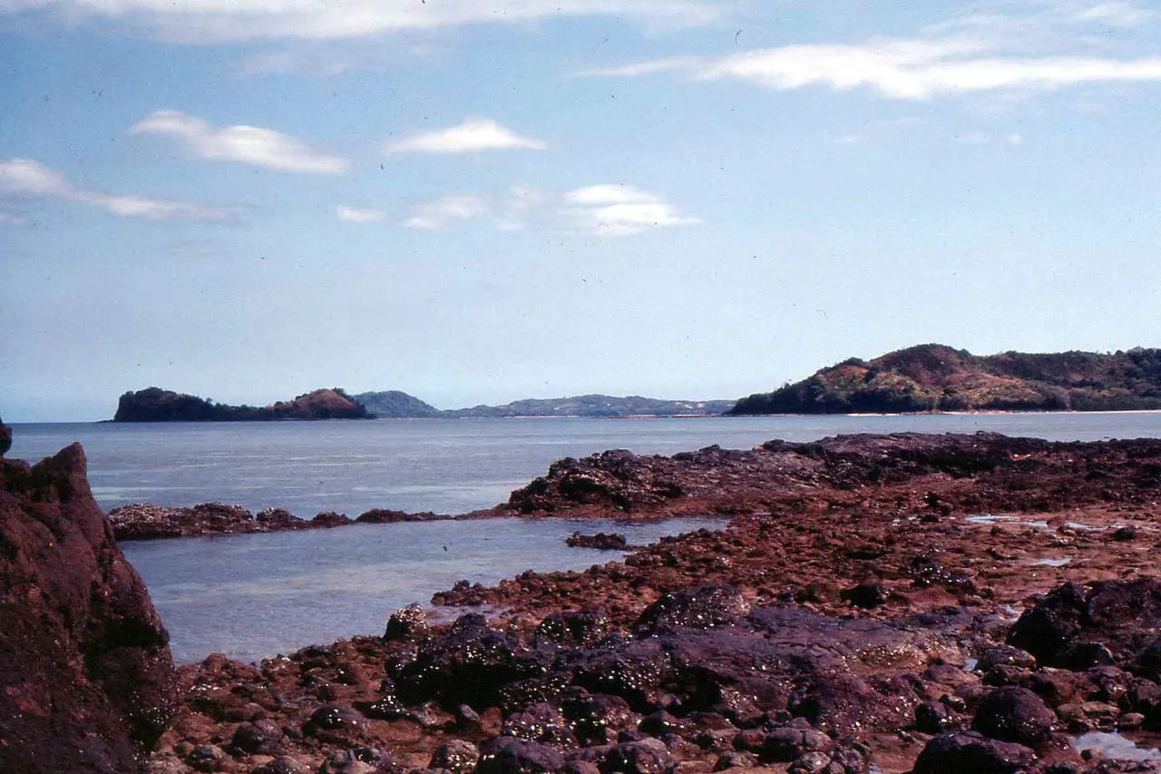 Felsküste von Nosy Be mit Inseln am Horizont